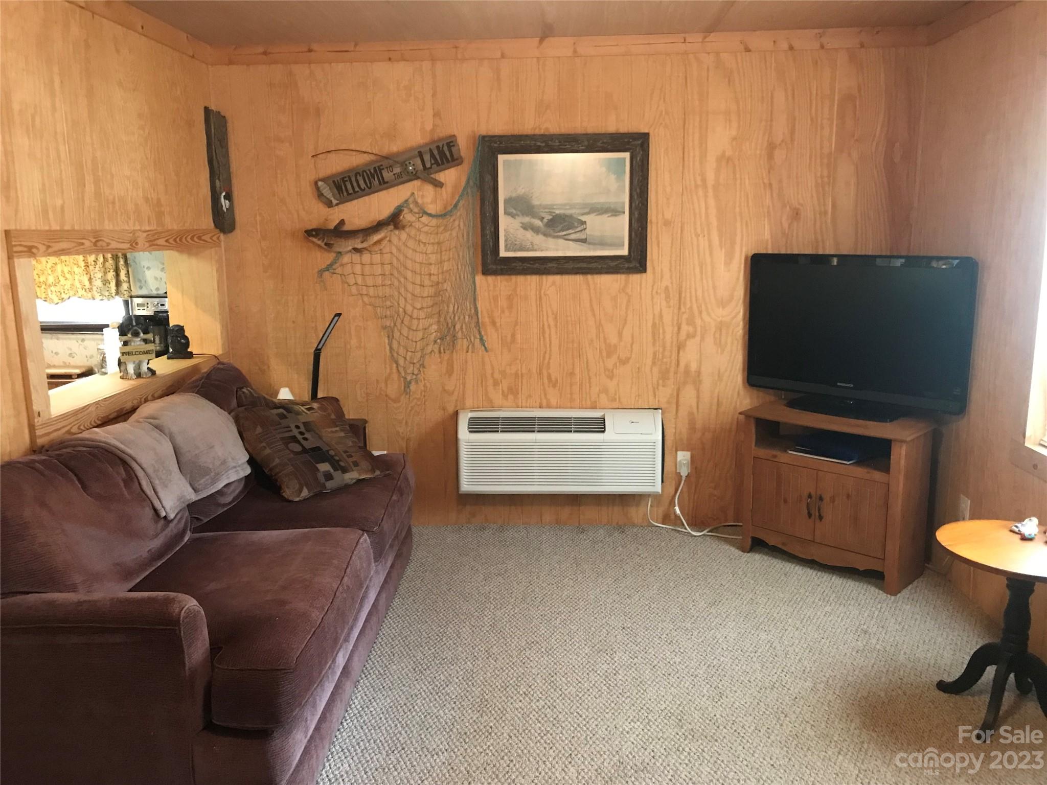 154 Roberts Ridge Road Mount Gilead, NC 27306 - Photo 12 of 35 a living room with furniture and a flat screen tv