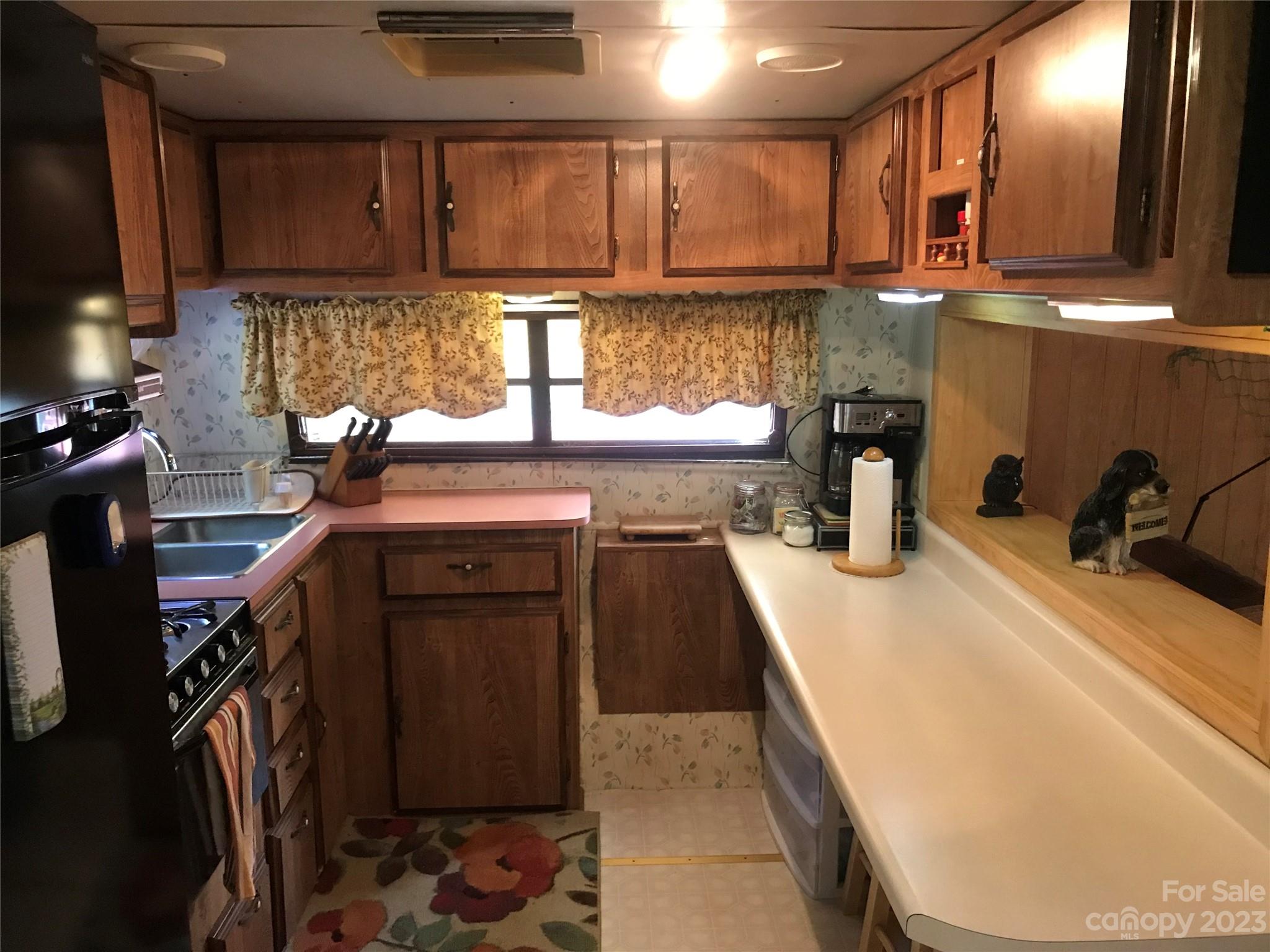 154 Roberts Ridge Road Mount Gilead, NC 27306 - Photo 16 of 35 a kitchen with stainless steel appliances granite countertop a sink a stove and a wooden cabinets