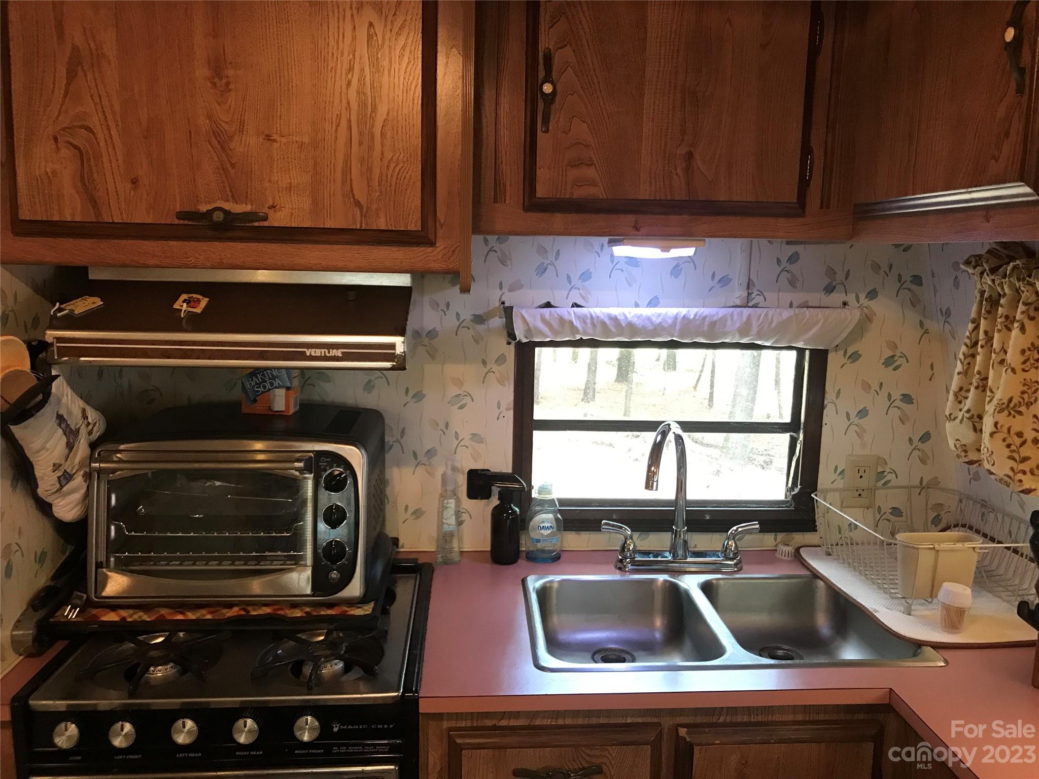 154 Roberts Ridge Road Mount Gilead, NC 27306 - Photo 18 of 35 a kitchen with a stove and a sink