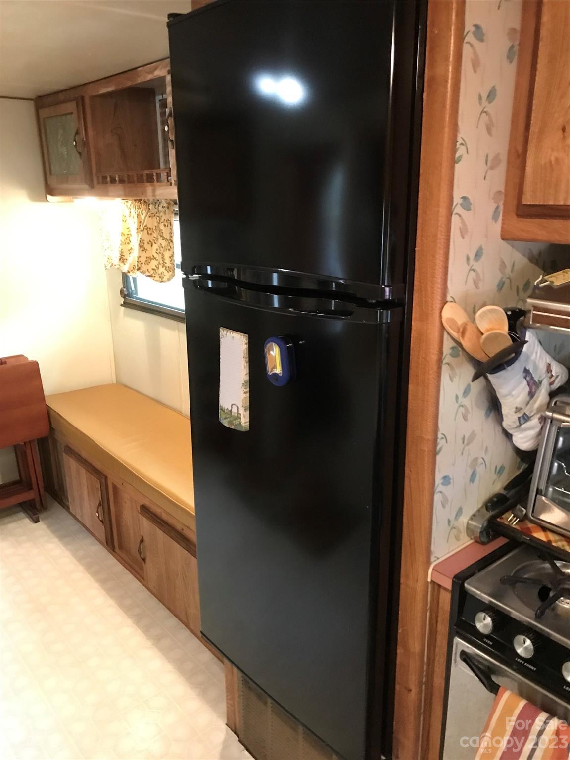 154 Roberts Ridge Road Mount Gilead, NC 27306 - Photo 19 of 35 a kitchen with a refrigerator and a stove