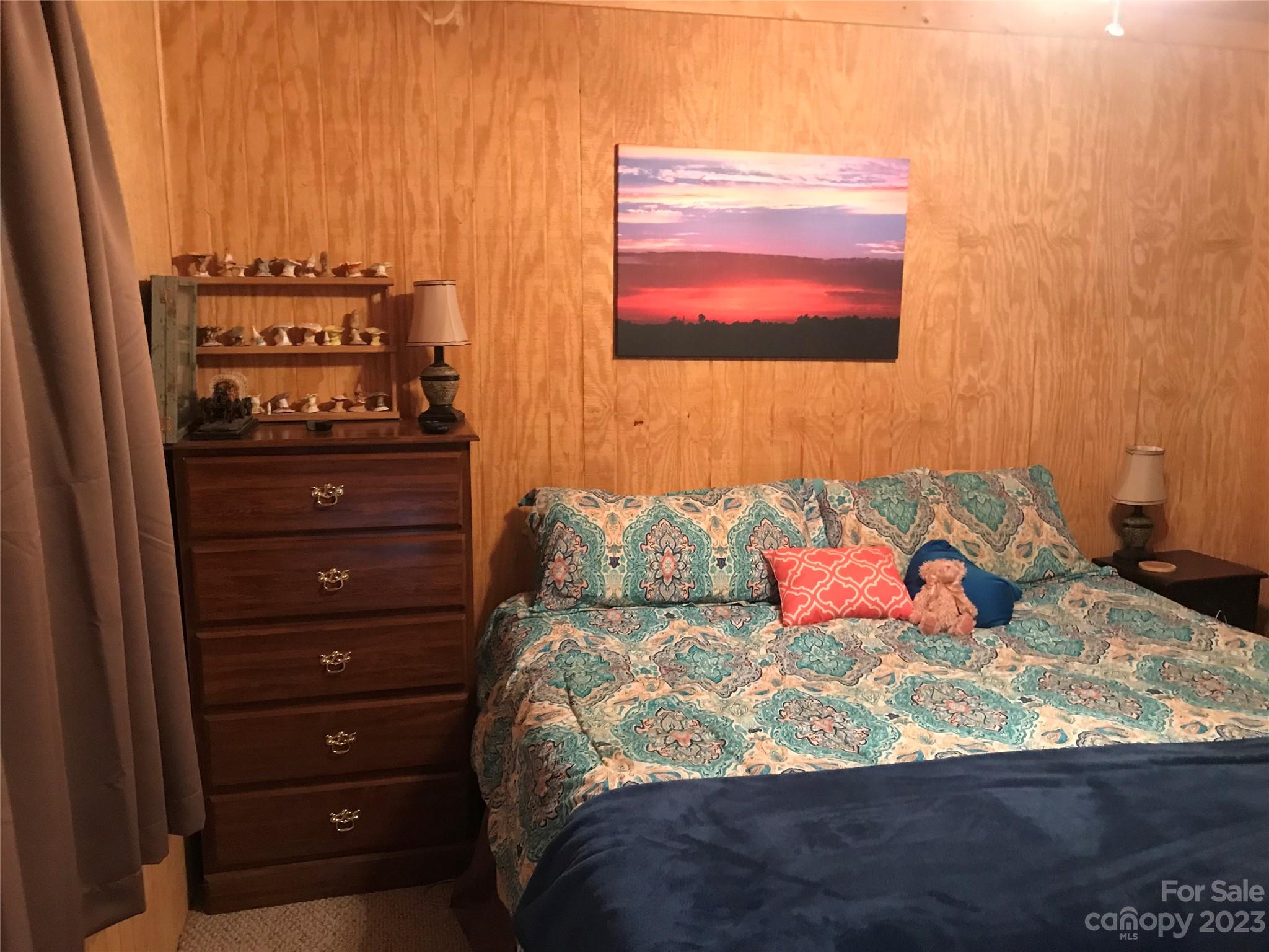 154 Roberts Ridge Road Mount Gilead, NC 27306 - Photo 22 of 35 a bed sitting in a bedroom next to a window