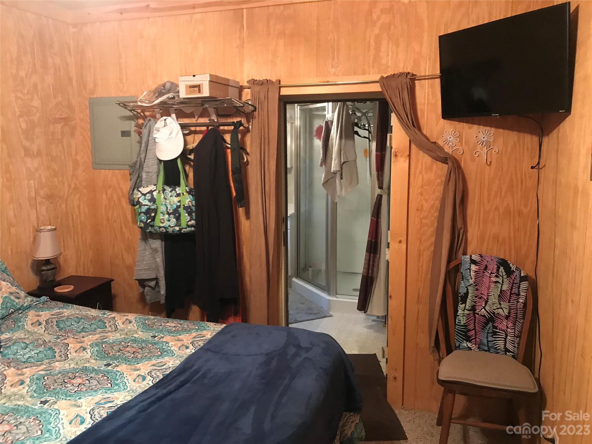 154 Roberts Ridge Road Mount Gilead, NC 27306 - Photo 24 of 35 a bedroom with a bed and flat screen tv