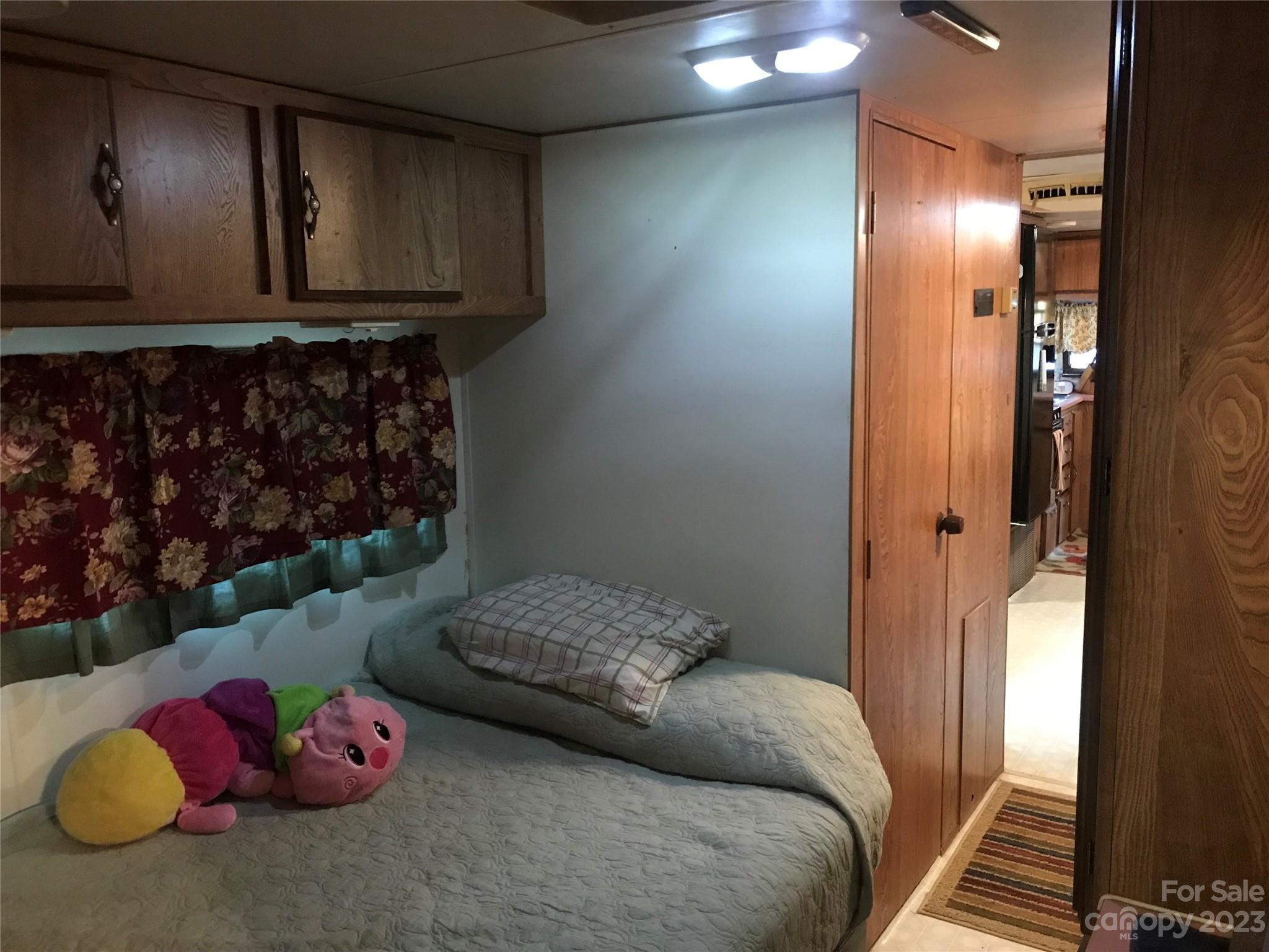 154 Roberts Ridge Road Mount Gilead, NC 27306 - Photo 30 of 35 a bedroom with a bed and cabinets