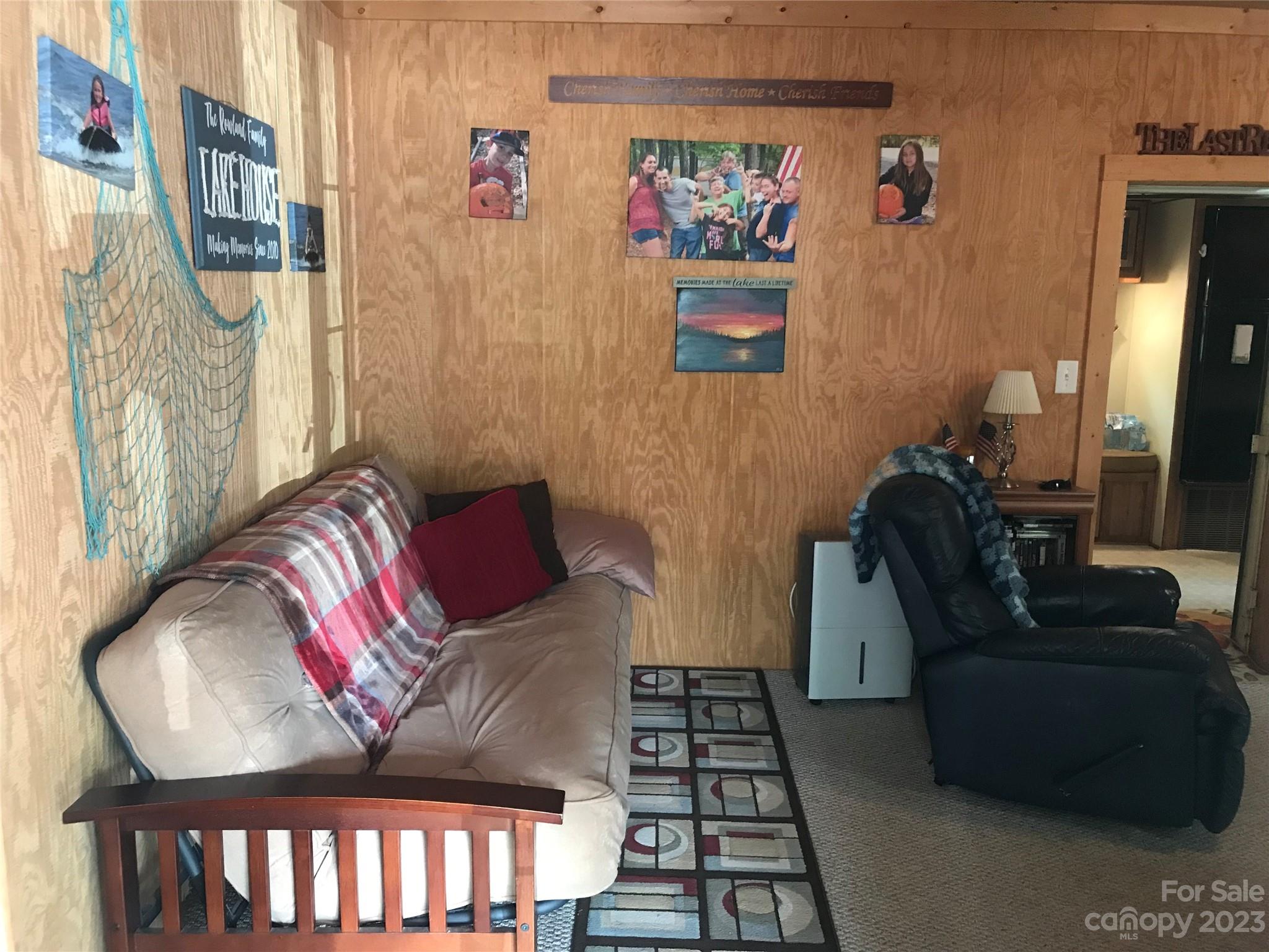 154 Roberts Ridge Road Mount Gilead, NC 27306 - Photo 9 of 35 a living room with furniture and a painting on the wall