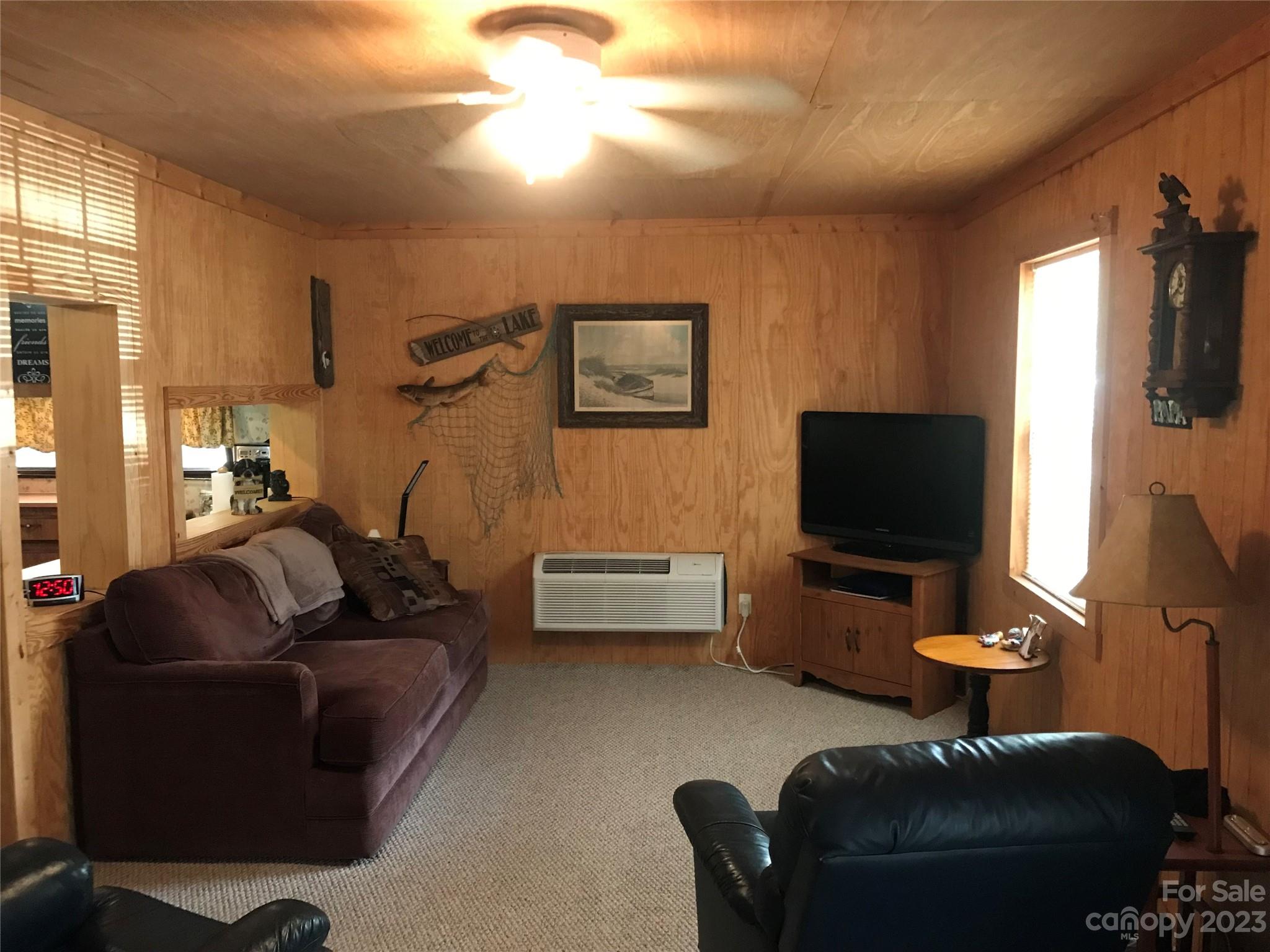 154 Roberts Ridge Road Mount Gilead, NC 27306 - Photo 10 of 35 a living room with furniture and a flat screen tv
