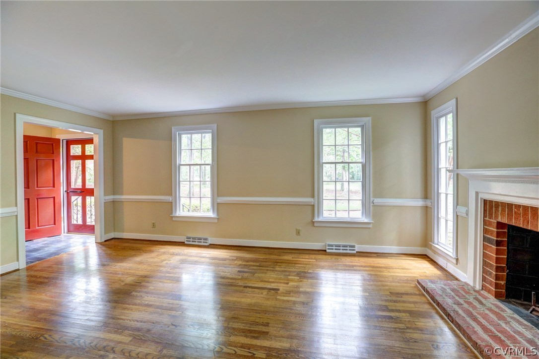 1970 Castlebridge Road Midlothian, VA 23113 - Photo 5 of 28 an empty room with wooden floor and fireplace