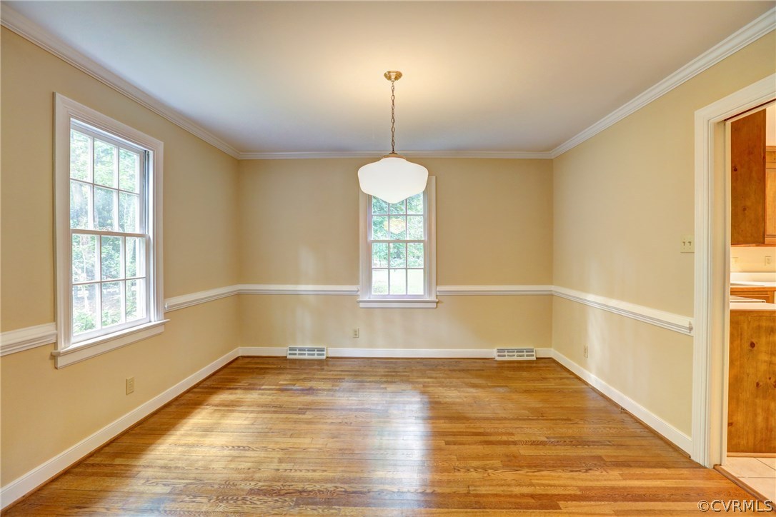 1970 Castlebridge Road Midlothian, VA 23113 - Photo 7 of 28 a view of a room with wooden floor chandeliers and kitchen view