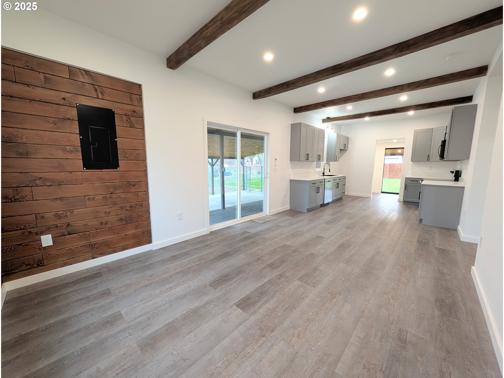 2906 North Oak Street La Grande, OR 97850 - Photo 14 of 37 a view of an empty room and a kitchen with wooden floor