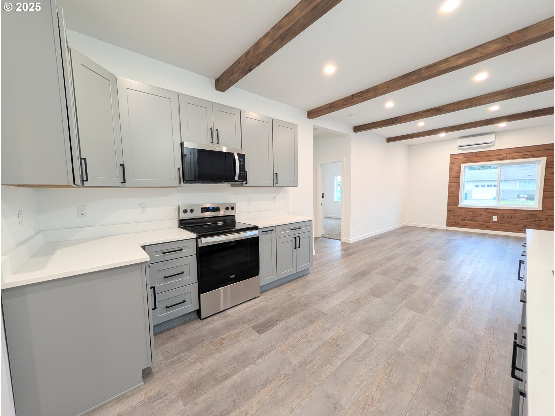 2906 North Oak Street La Grande, OR 97850 - Photo 7 of 37 a kitchen with granite countertop a stove top oven a sink and a microwave