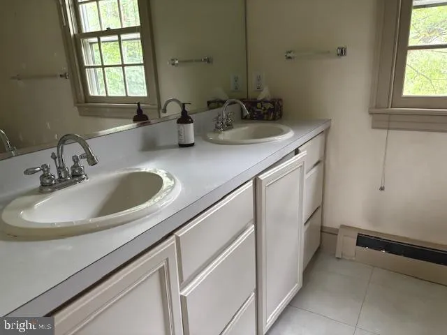 a bathroom with a sink and a window