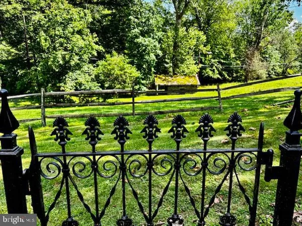 a view of swimming pool with a garden and trees