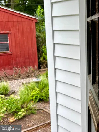 a view of a yard with wooden fence