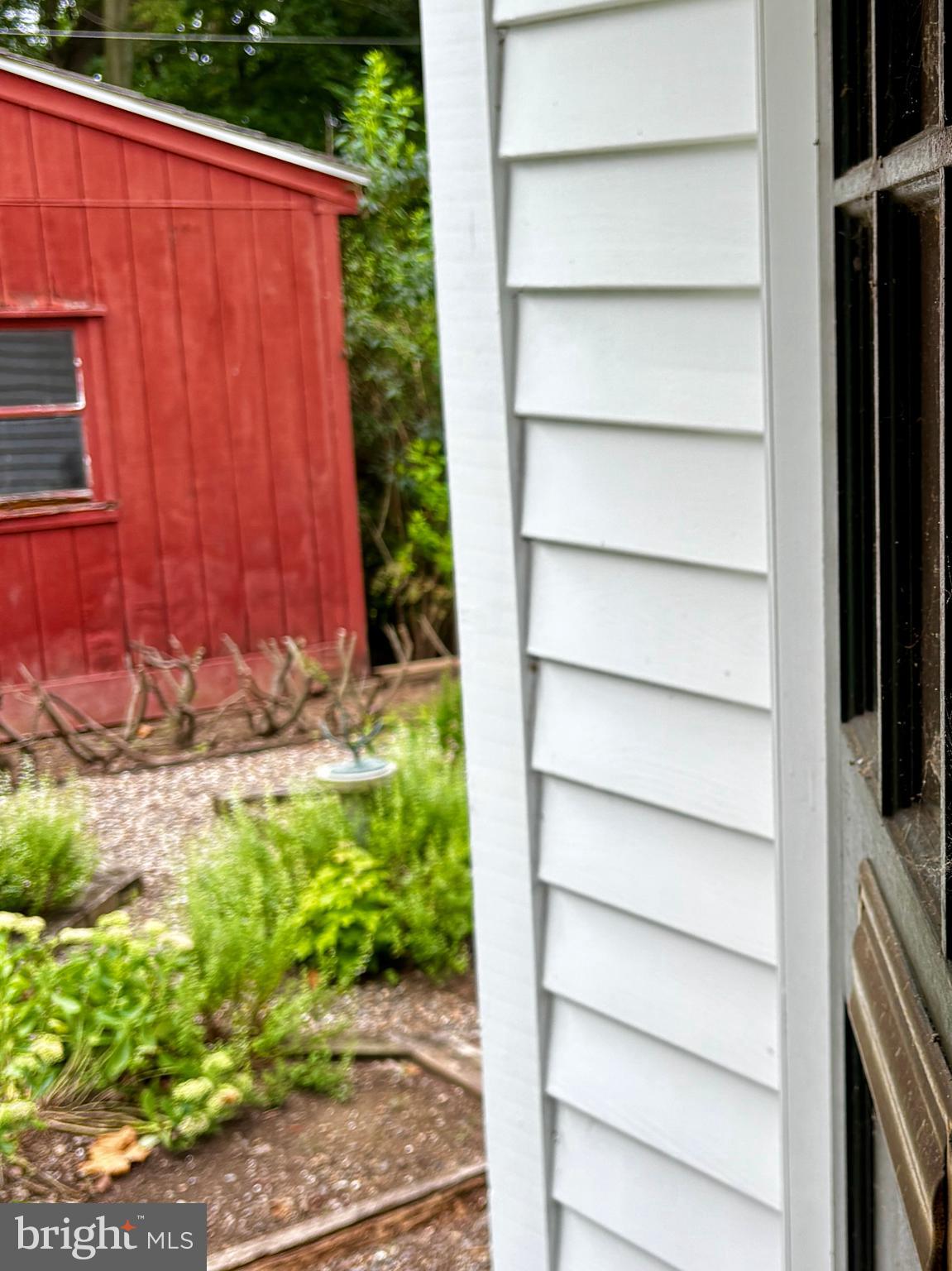 410 Wharf Road, Unit RIVER Bensalem, PA 19020 - Photo 48 of 62 a view of a backyard with potted plants and wooden fence