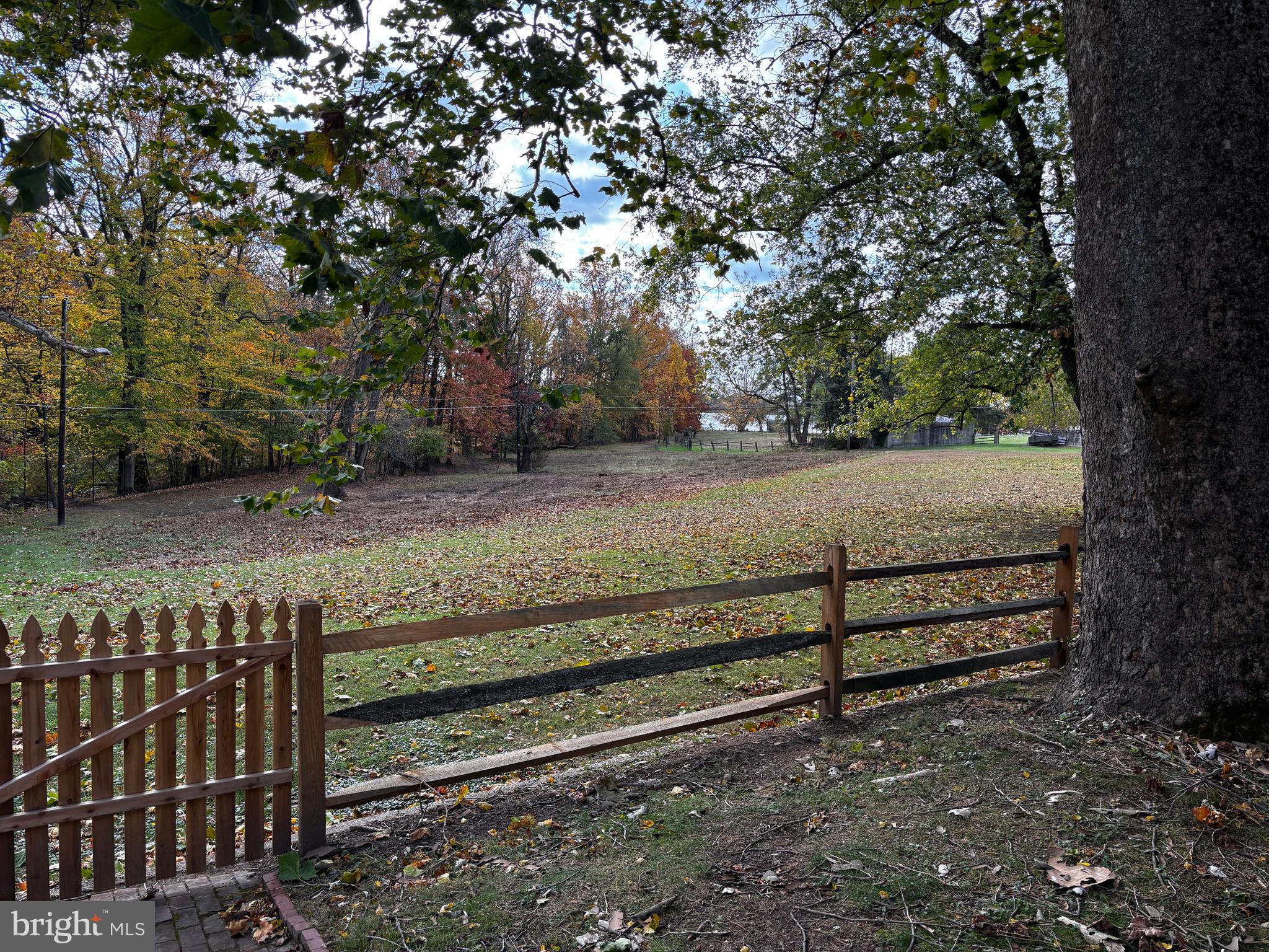 410 Wharf Road, Unit RIVER Bensalem, PA 19020 - Photo 58 of 62 a view of a yard with wooden fence and trees