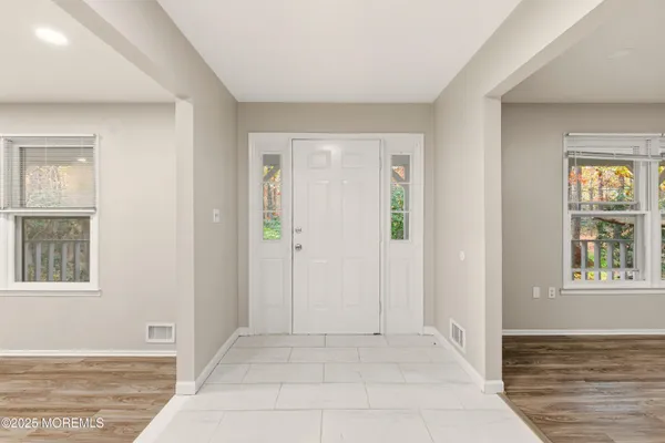 an empty room with windows and closet