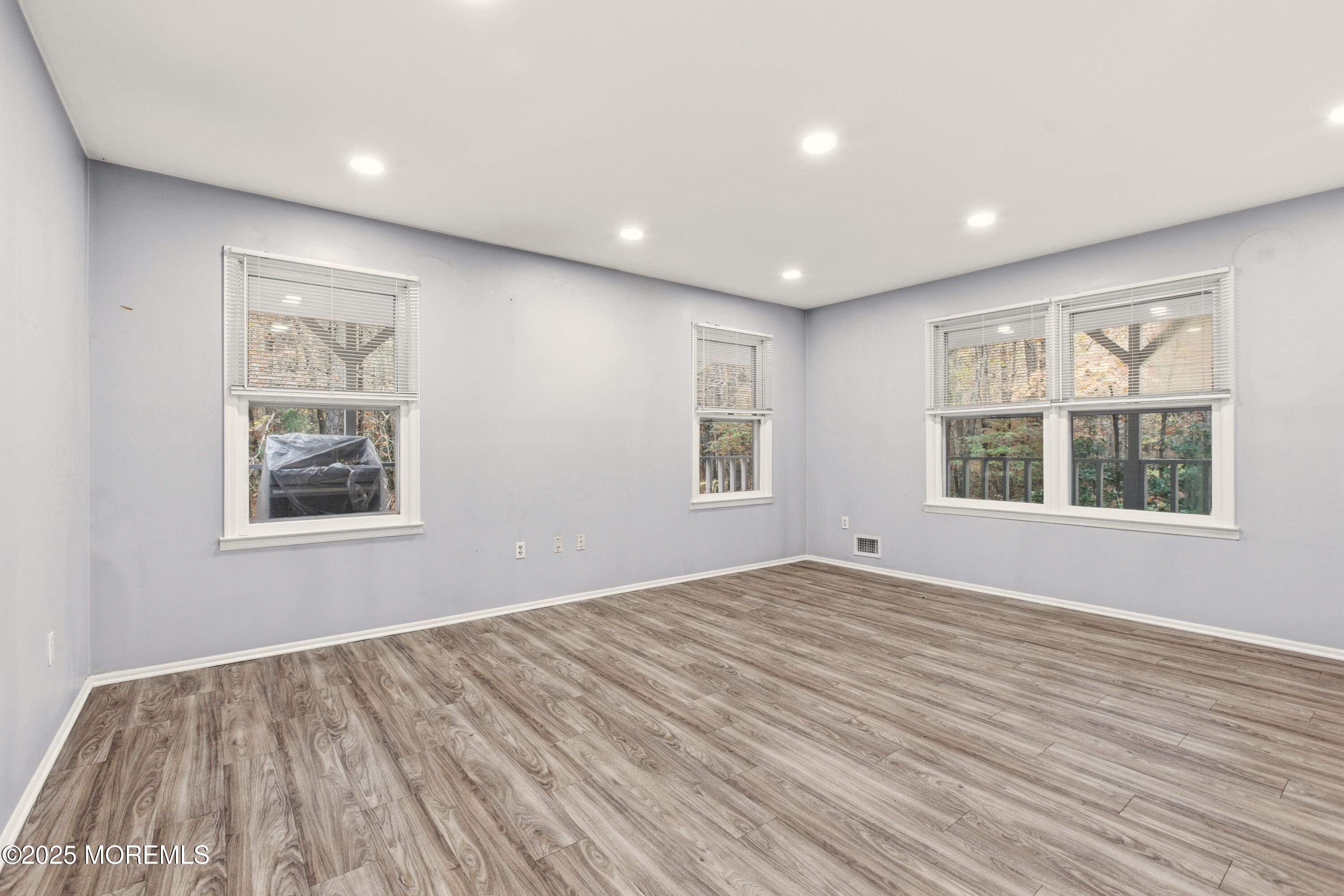 683 Anderson Road Jackson, NJ 08527 - Photo 6 of 10 a view of an empty room with wooden floor and a window