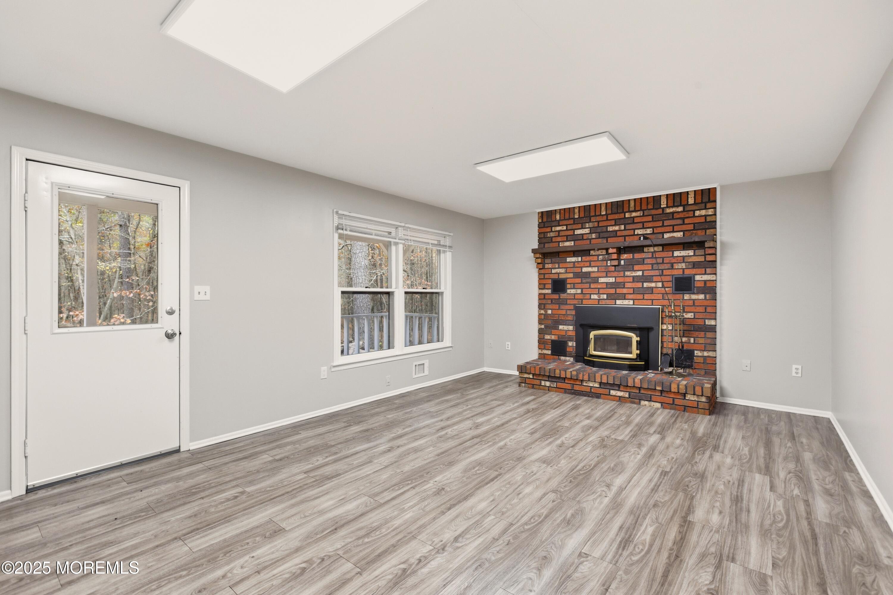 683 Anderson Road Jackson, NJ 08527 - Photo 9 of 10 a view of empty room with wooden floor and fireplace