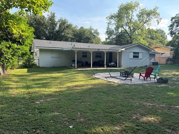 a view of a house with pool and a yard