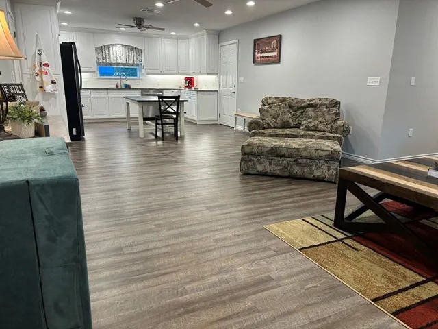 a living room with furniture and kitchen view