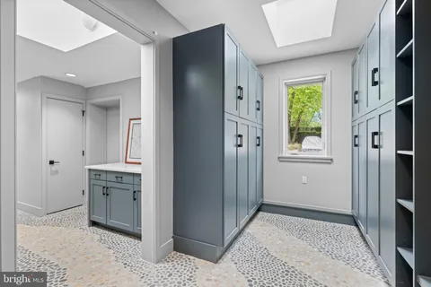 a view of a kitchen with a sink and a refrigerator