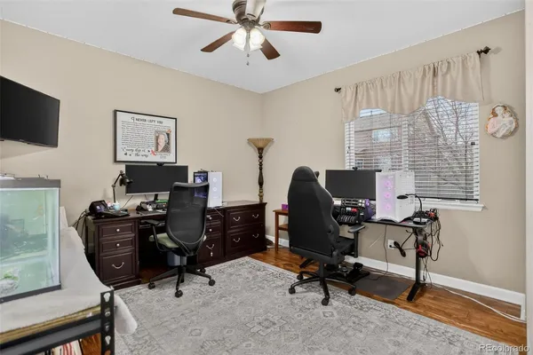 a view of a workspace with furniture and a window