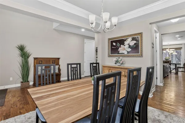a view of a dining room with furniture wooden floor and chandelier