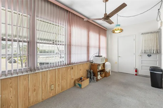 a very nice looking room with a large window and furniture