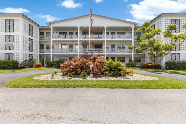 a front view of building with yard