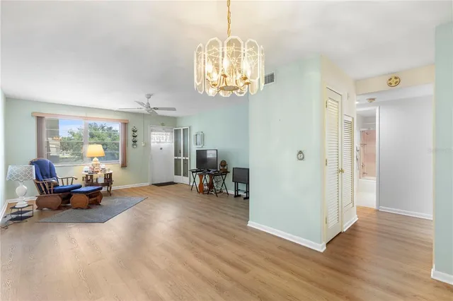 a view of a livingroom with workspace and a window