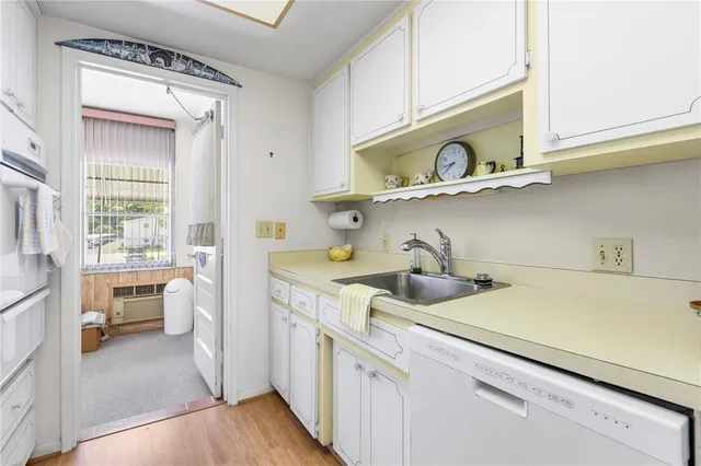a kitchen with a stove a sink and a microwave