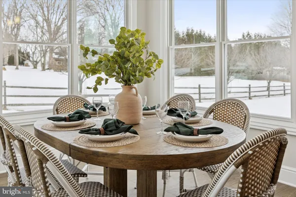 a table with a vase and flowers on it