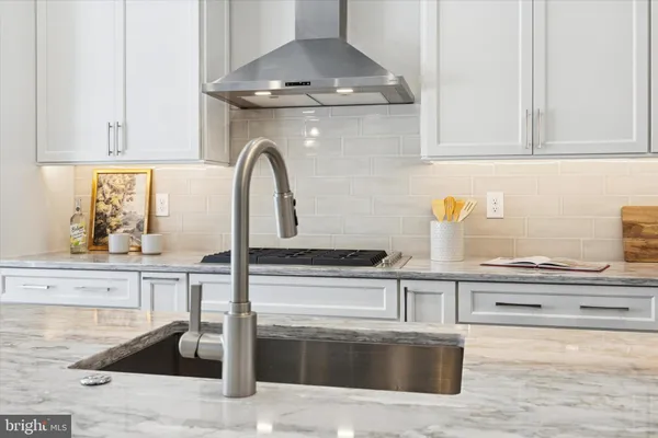 a kitchen with granite countertop a stove and a sink