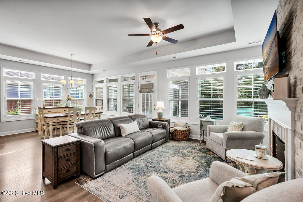 142 Rice Marsh Way Wilmington, NC 28412 - Photo 25 of 64 The living and dining areas are beautifully drenched in sunlight thanks to a bank of large, energy-efficient Low-E windows. Outfitted with custom plantation blinds, these windows allow for an easy transition between indoor and outdoor spaces and add an air of southern coastal charm to the neutral seaside color palette. A tray ceiling and an electric fireplace with custom brick surround complete this bright and open space.