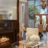 a dining room with furniture a fireplace and wooden floor