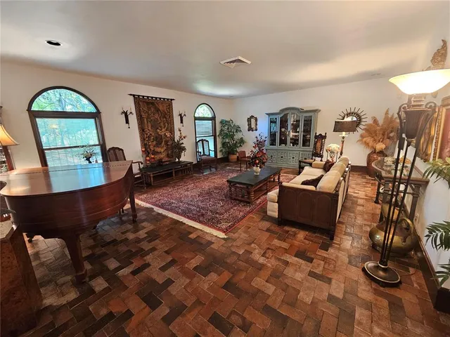 a living room with large mirror and furniture