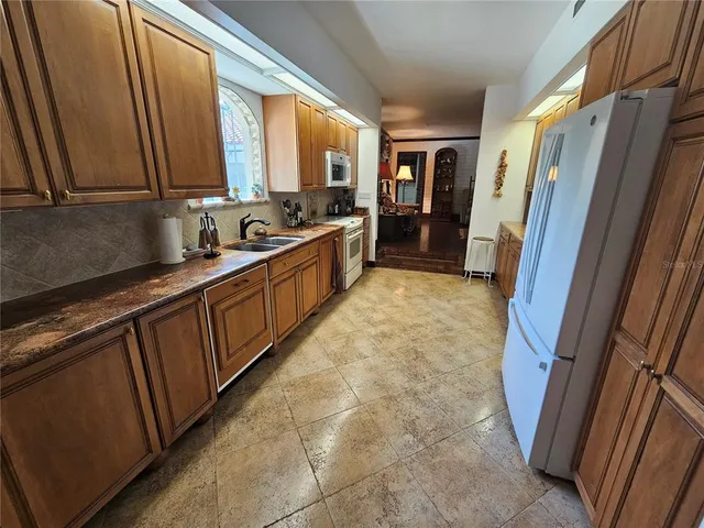 a kitchen with a sink window and cabinets