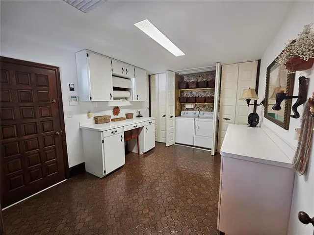 a living room with furniture fireplace and a large window