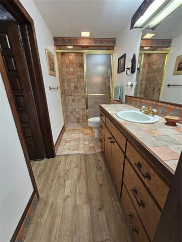 a spacious bedroom with two beds and a desk