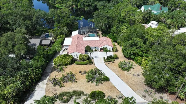 an aerial view of a house with yard swimming pool and outdoor seating