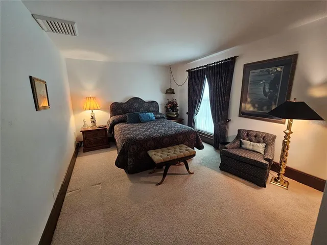 a living room with furniture a rug and a large window