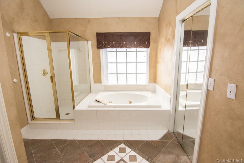 3434 Blue Jay Pass Fort Mill, SC 29708 - Photo 13 of 24 a bathroom with a bathtub and a shower