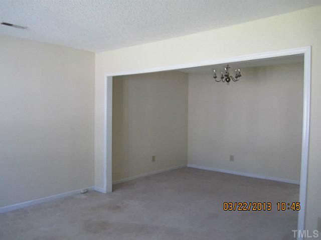 7615 Ladden Court Raleigh, NC 27615 - Photo 7 of 19 an empty room with a bench