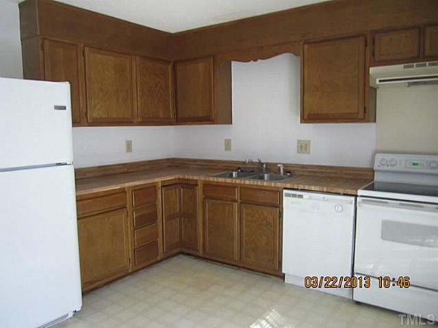 7615 Ladden Court Raleigh, NC 27615 - Photo 8 of 19 a kitchen with sink cabinets and white appliances