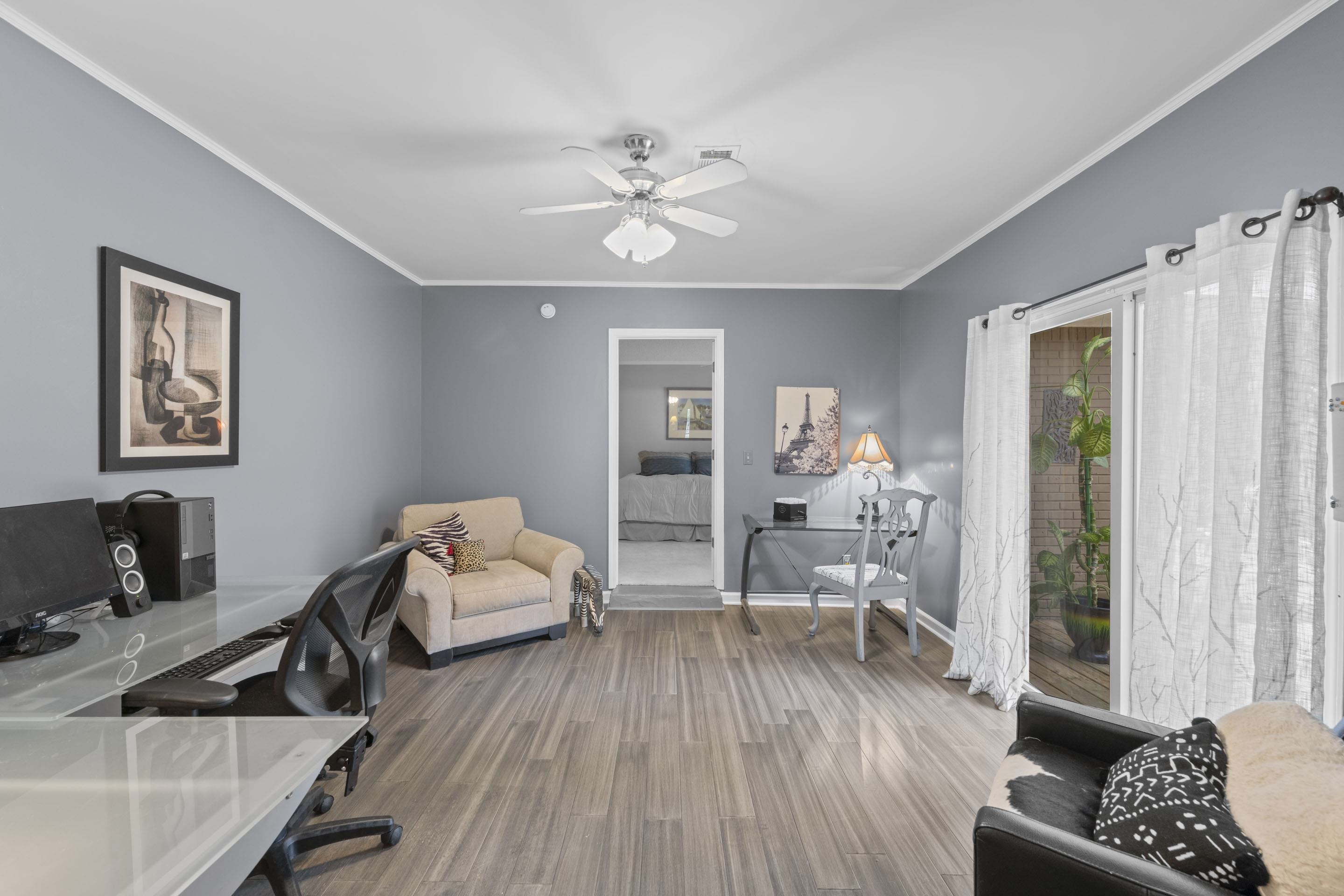 219 North Rose Road Memphis, TN 38117 - Photo 14 of 30 A versatile office with double sliding glass doors, offering natural light and a dedicated space for remote work or creative projects.