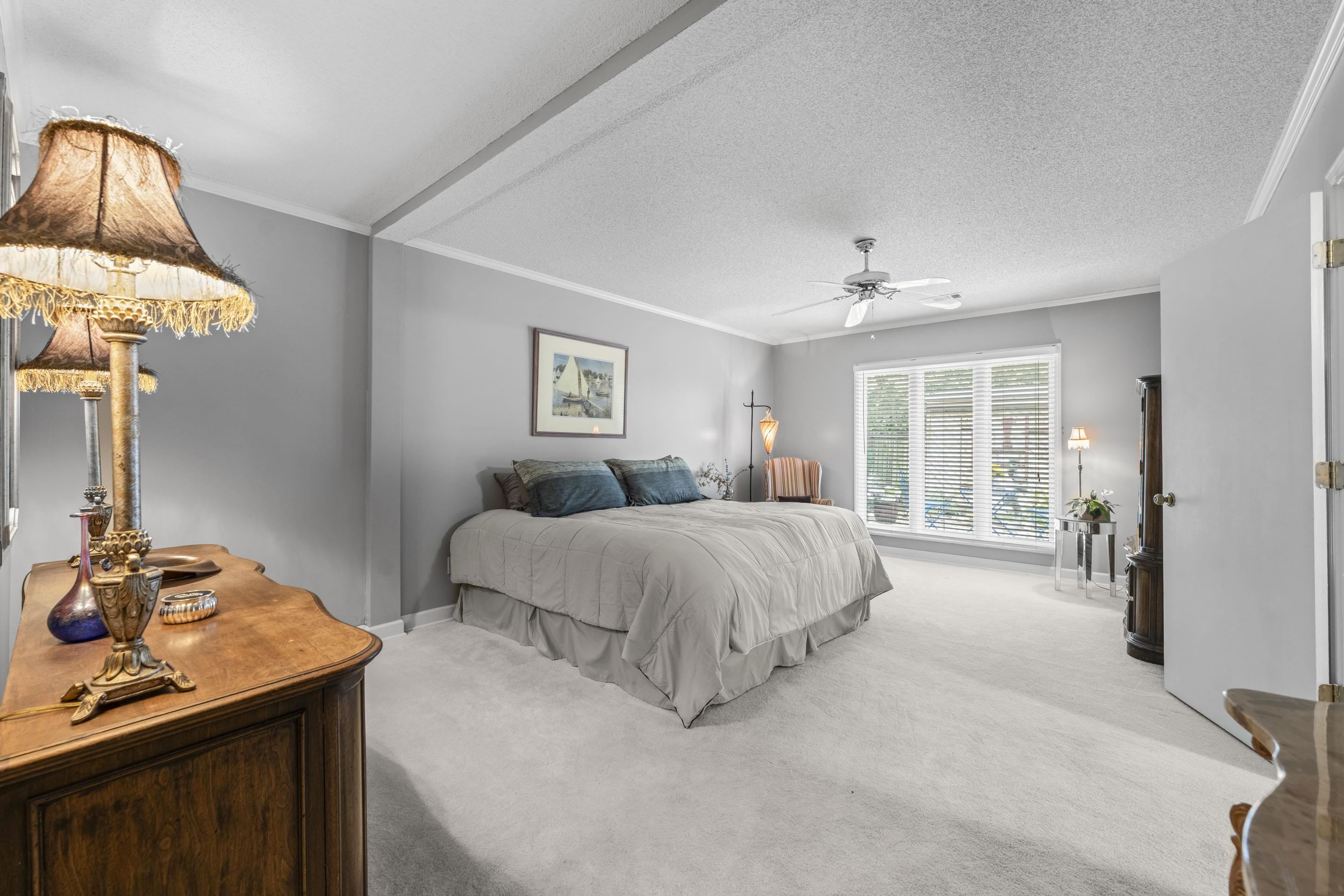 219 North Rose Road Memphis, TN 38117 - Photo 15 of 30 Retreat to the primary suite, a restful sanctuary offering a walk-in closet and an updated ensuite with elongated dual-vessel vanity and walk-in shower—pure modern romance.