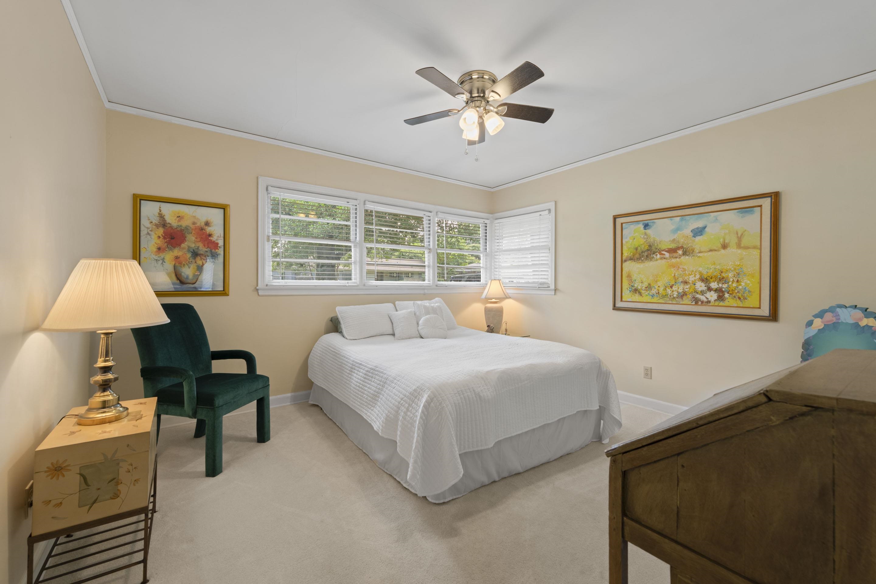 219 North Rose Road Memphis, TN 38117 - Photo 19 of 30 Have sweet dreams in the second bedroom complete with soft carpeting, neutral color palette, ceiling fan and a closet.