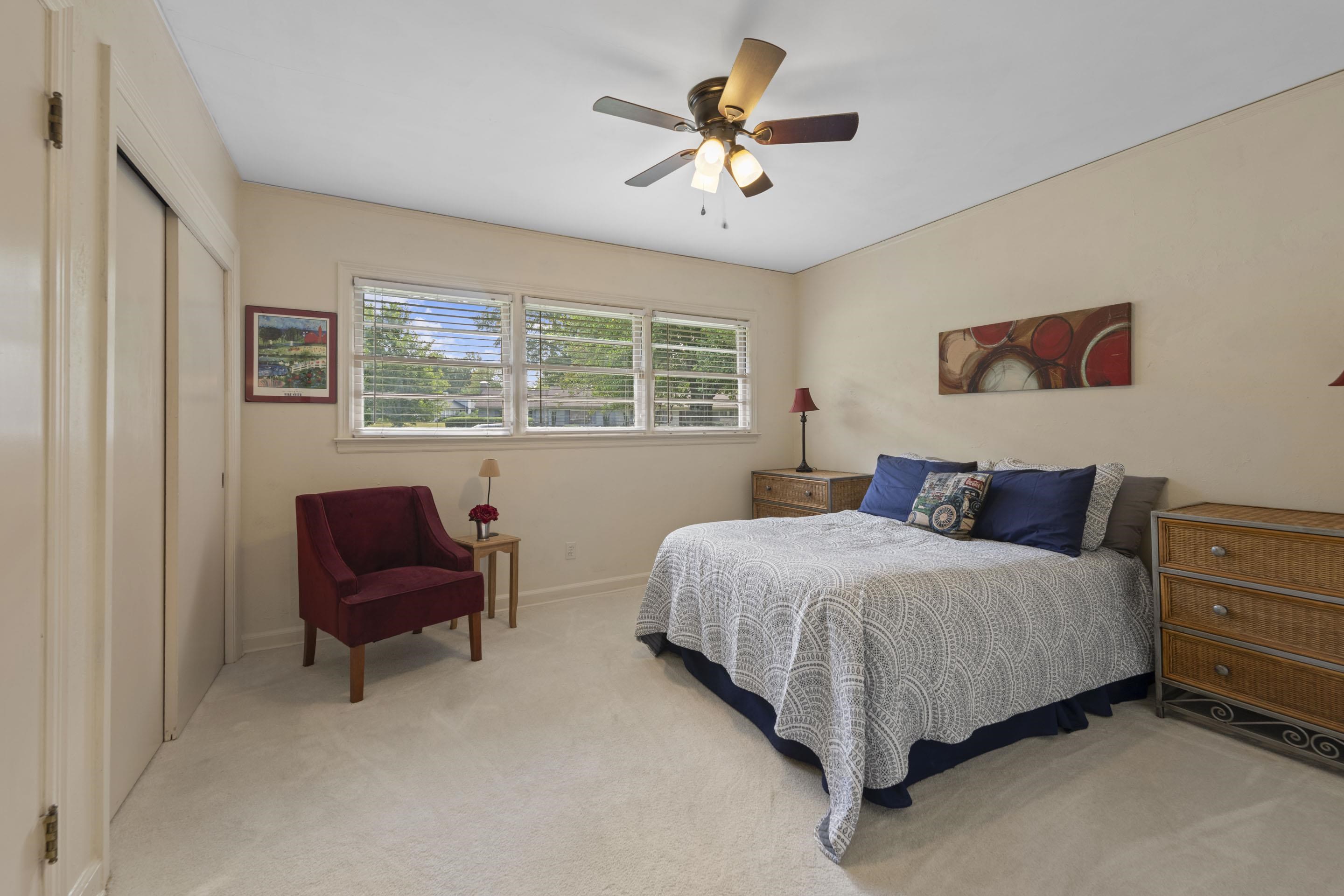219 North Rose Road Memphis, TN 38117 - Photo 21 of 30 Rest and recharge in the third bedroom featuring neutral colors, cooling ceiling fan, closet and soft carpeting.