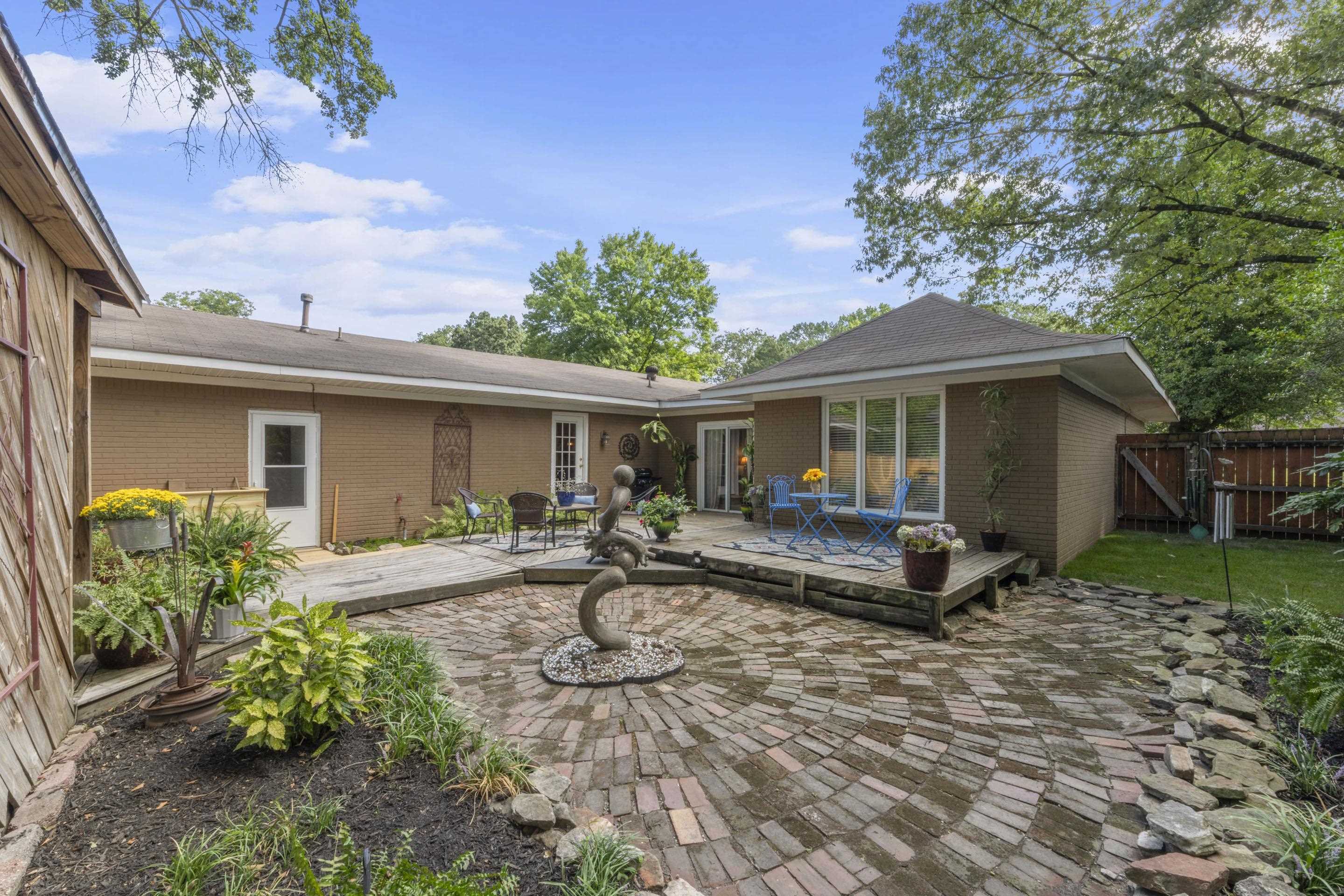 219 North Rose Road Memphis, TN 38117 - Photo 26 of 30 Back of property featuring a patio area, brick siding, a shingled roof, and a gate