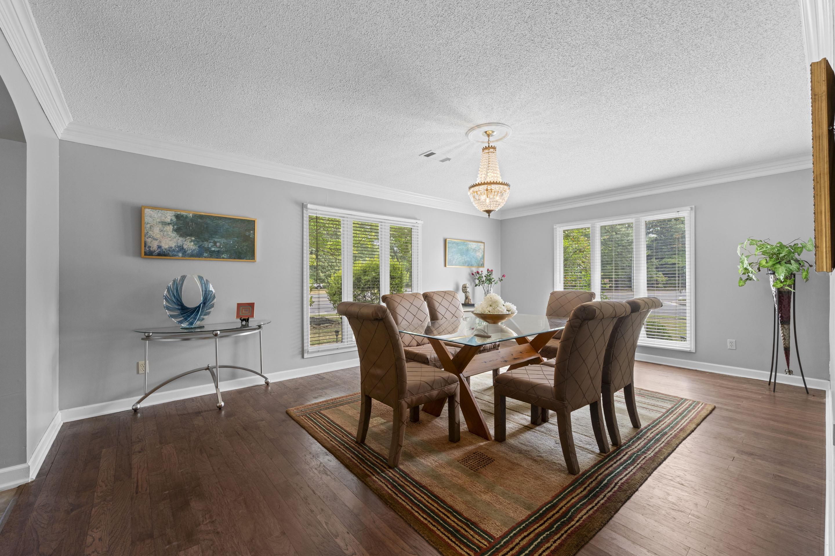 219 North Rose Road Memphis, TN 38117 - Photo 3 of 30 Dine in style in the formal dining room, distinguished by beautiful hardwood floors and a dazzling chandelier.