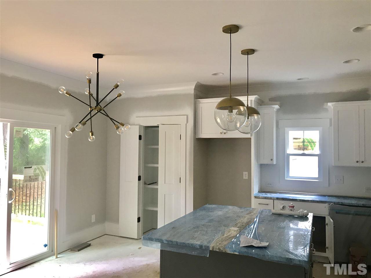 1320 Foxrun Drive Raleigh, NC 27610 - Photo 3 of 24 Nice size kitchen w/ large island. Under cabinet lighting and modern light fixtures. SS Gas Range, Microwave & Dishwasher. Granite Countertops. Engineered Hardwood Floors.